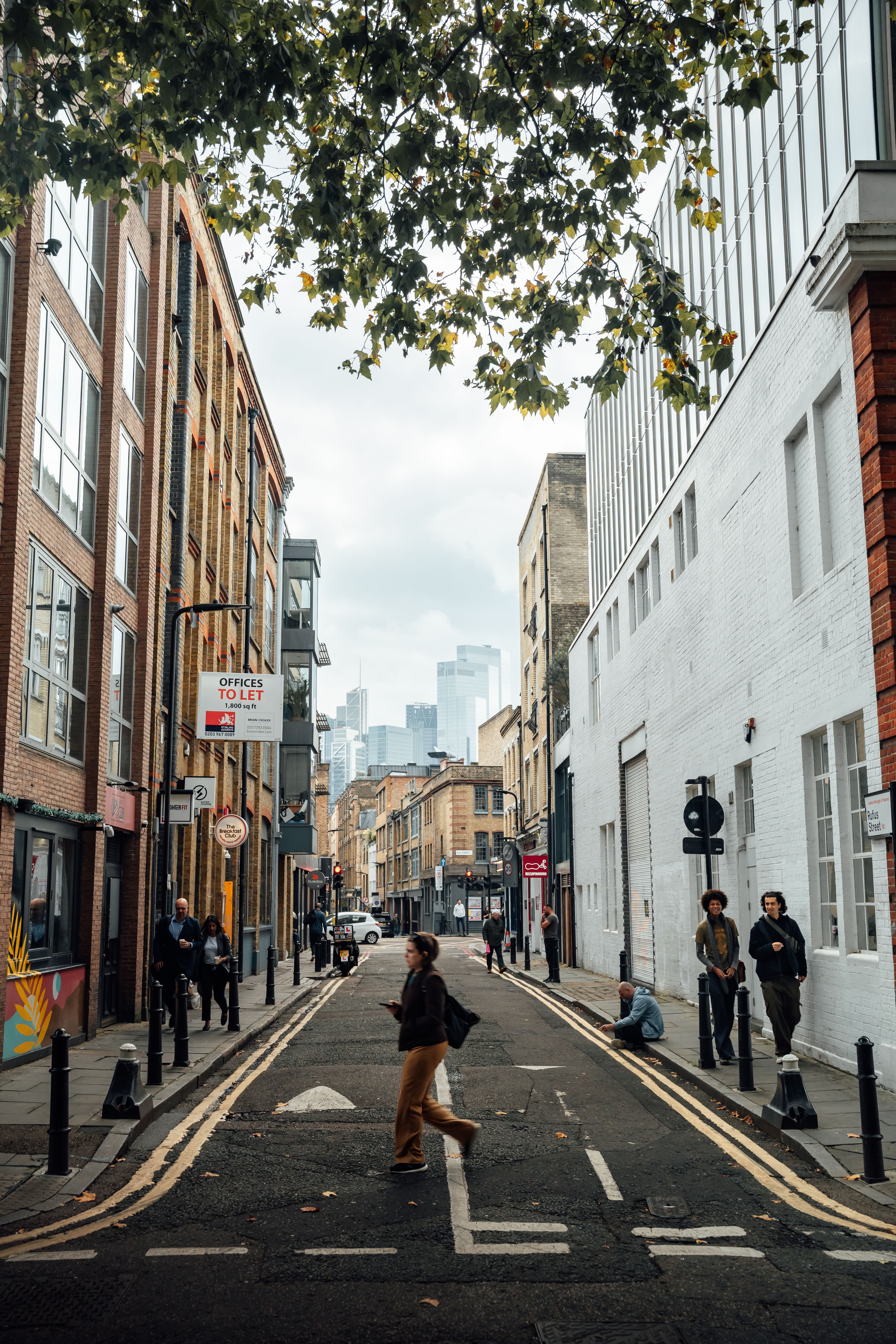 Street scene in Shoreditch with a modern London skyline in the background.