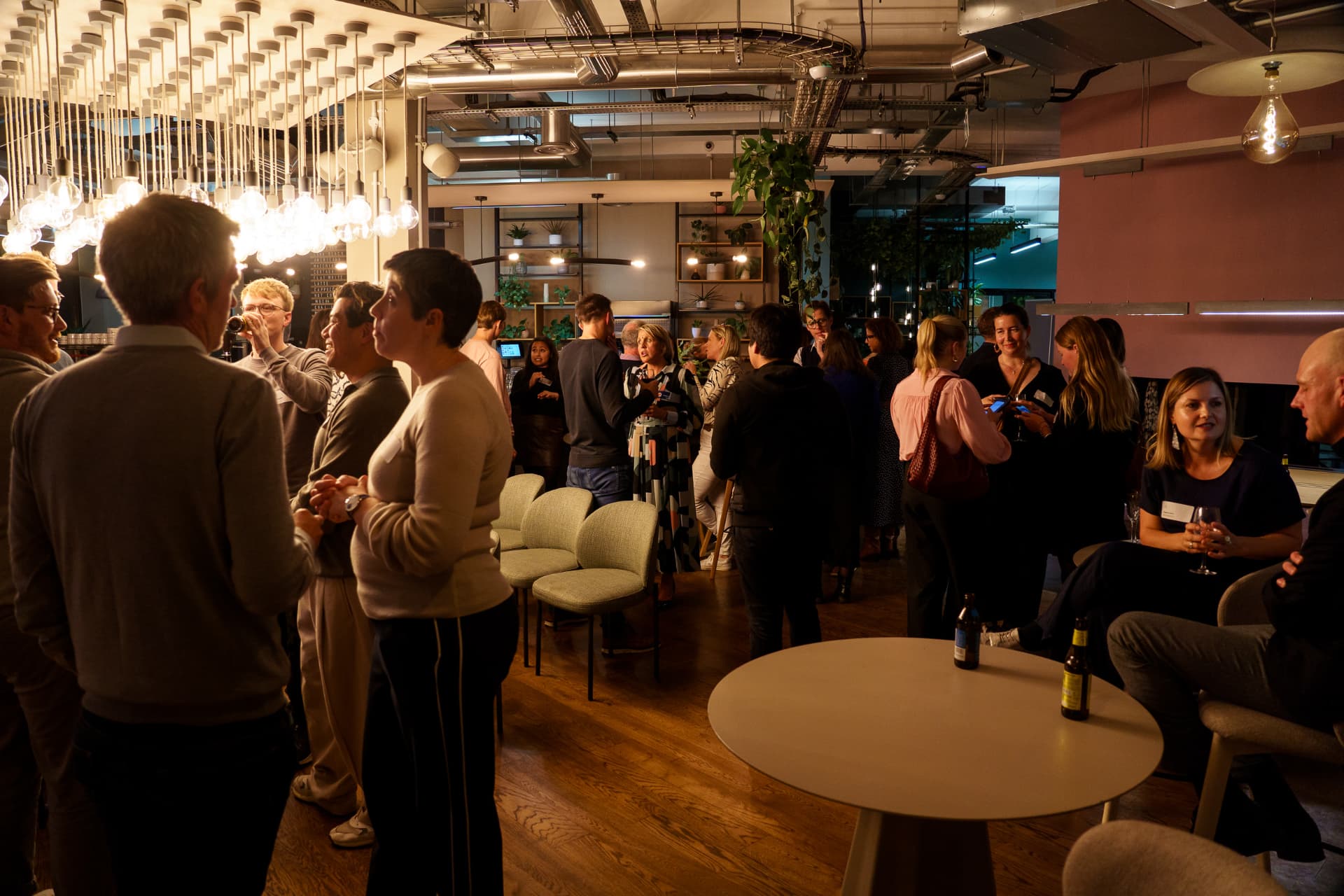 Guests in conversation across the room at a NoBa Connect event.