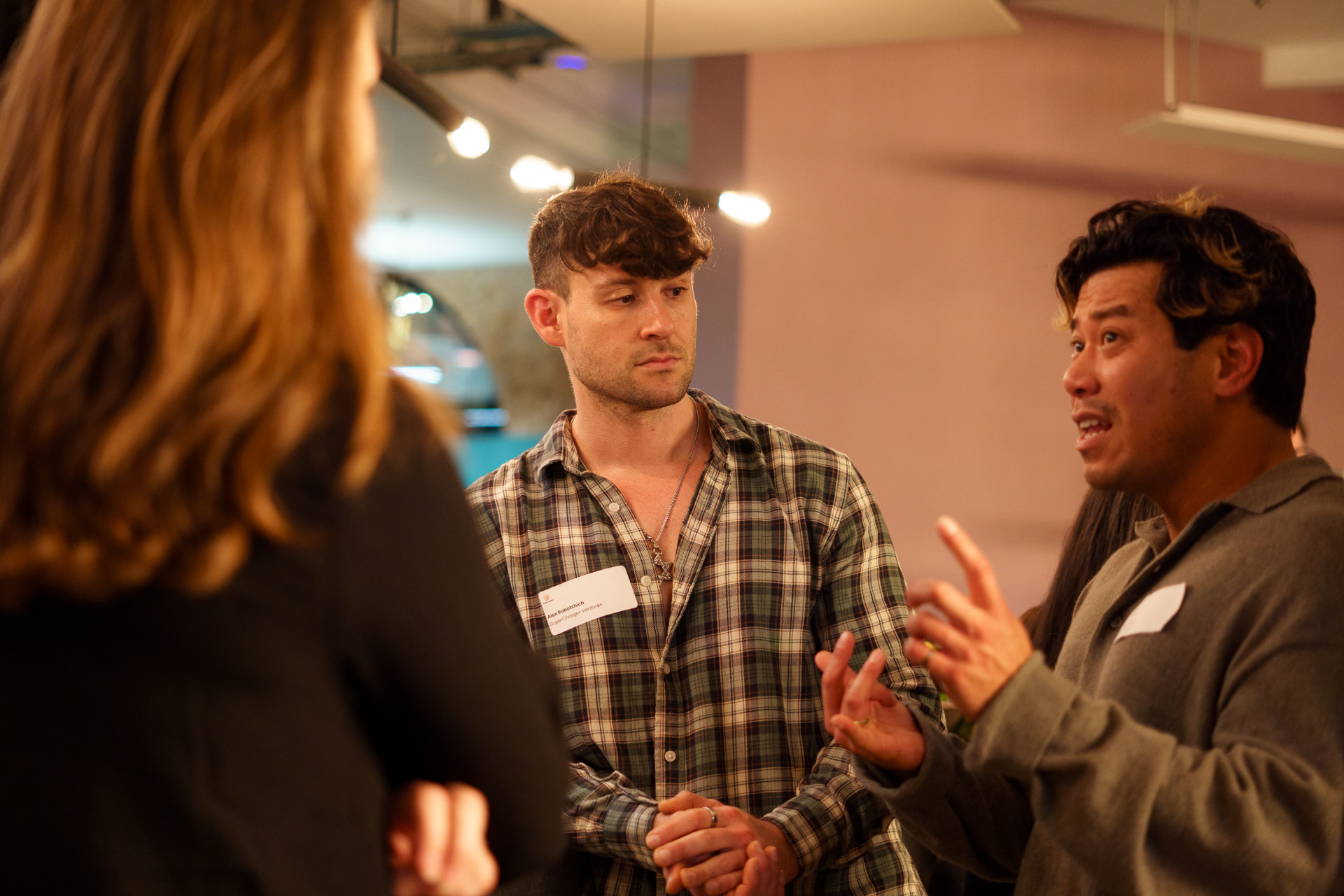 Attendees in animated discussion at a NoBa event.